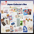 A collage-style promotional graphic for a limited edition Japan collector's box curated stationery set. The image shows many small stationery and collectible items arranged on a light textured background, with labels pointing to each category: washi and PET tape, postcards, journals, stickers, charms, pins, stamps, inks, ephemera, and a tote bag.