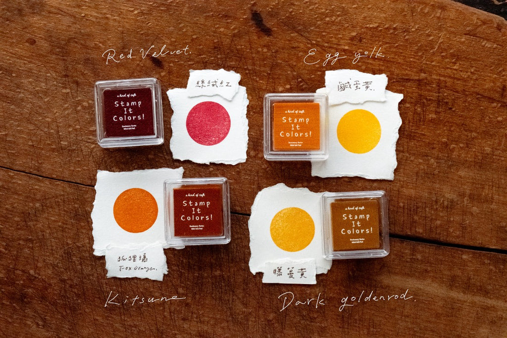 Set of stamp ink pads with different colors on a wooden surface