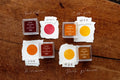 Set of stamp ink pads with different colors on a wooden surface